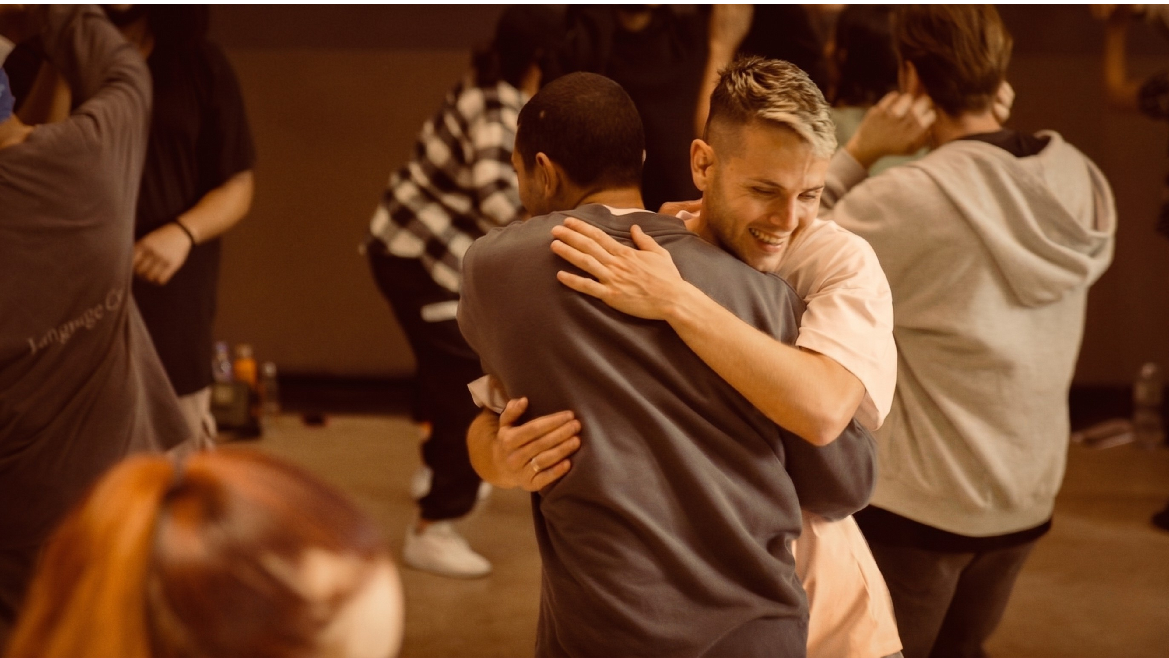 Two BTM Tribe dancers hugging warmly during BTM Intensive 2025 in Paris